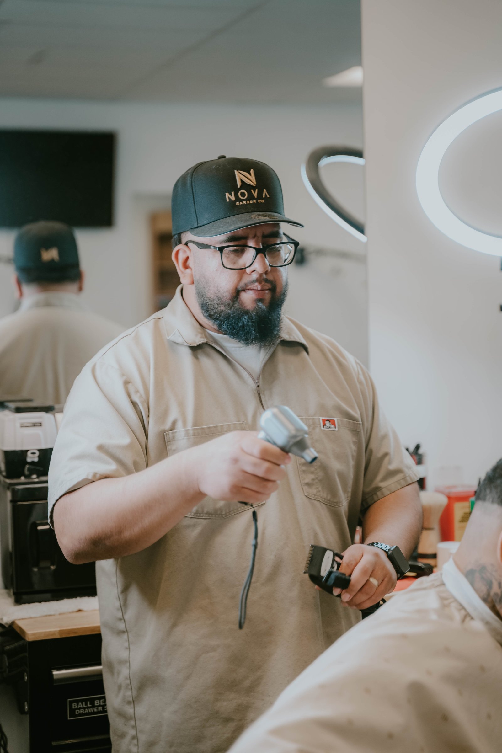 Barber at Nova Barber Co working at the station