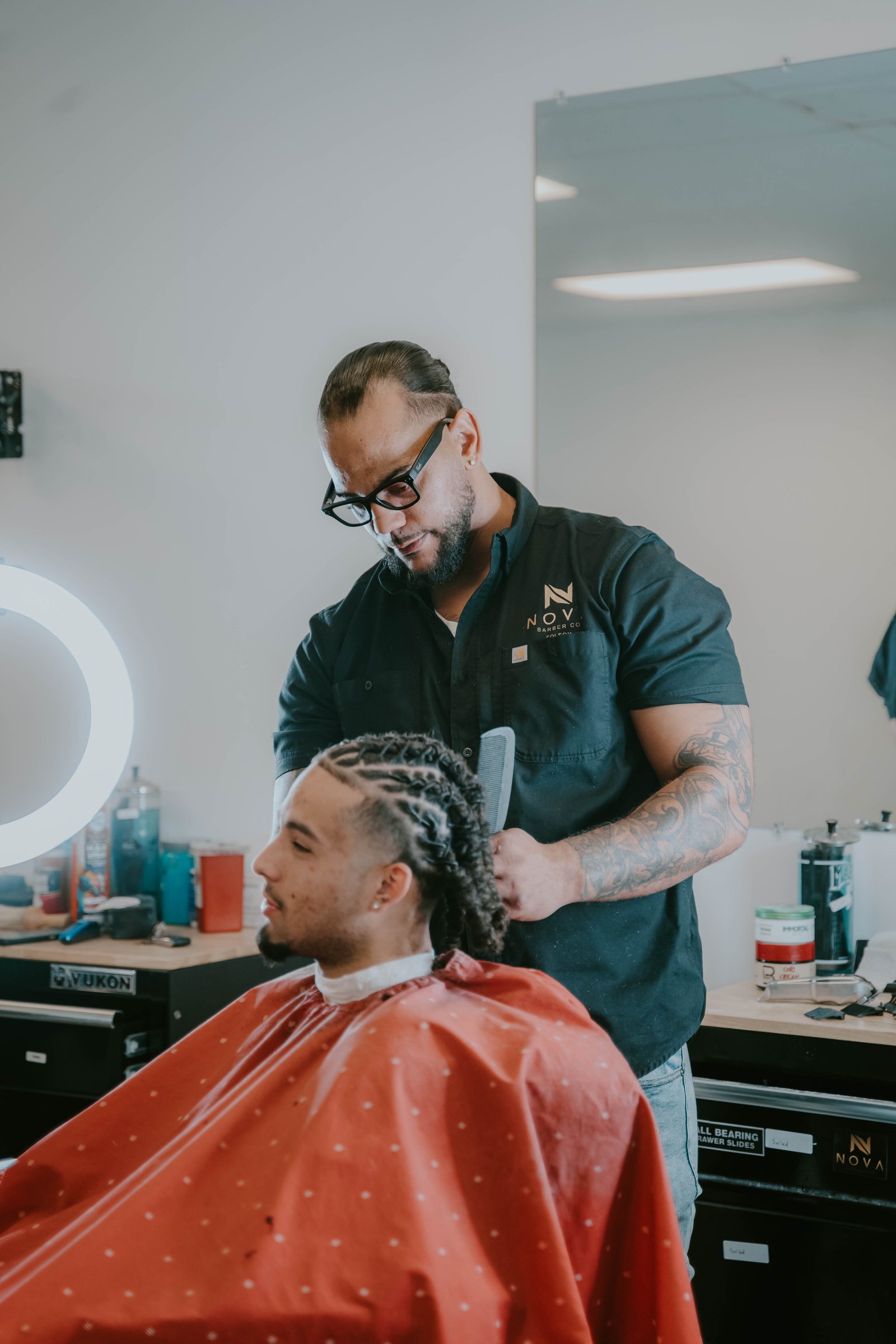 Barber styling braids for a client