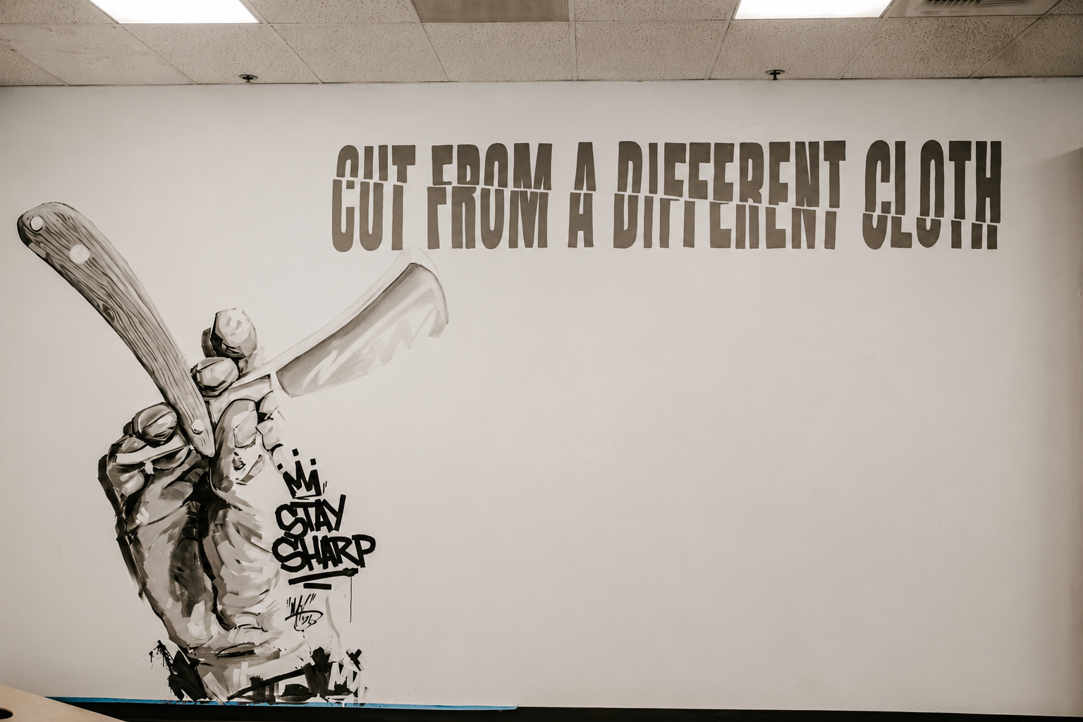 Cut From A Different Cloth mural wall at Nova Barber Co